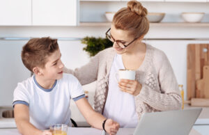 PositiveMotherAndBoyRestingInTheKitchen