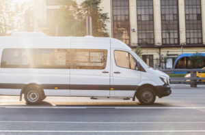 WhiteMinibusGoesOnTheCityStreet