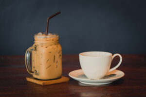 IceCoffeeWithHotCoffeeOnWoodTableWithDark