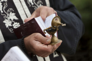 OrthodoxPriestHeldHolyBookAndBurningChurchIncense