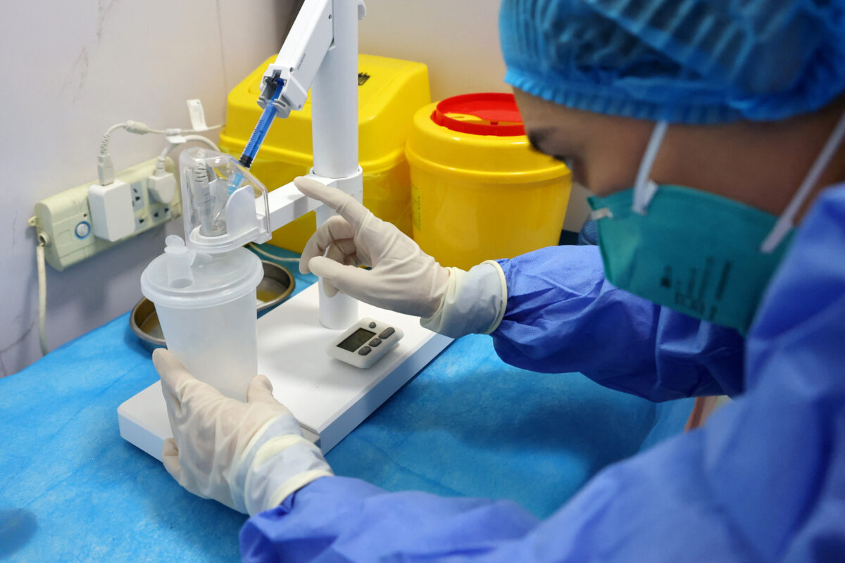Medical-worker-prepares-an-inhaled-COVID-19-vaccine-produced-by-CanSino-Biologics-at-a-community-health-service-centre-in-Lianyungang-Jiangsu