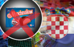 ManPushingShoppingCartFullOfFoodInTheSupermarket