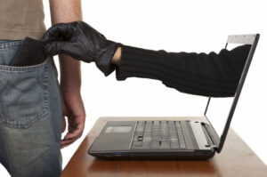 InternetTheft-AGlovedHandReachingThroughALaptop