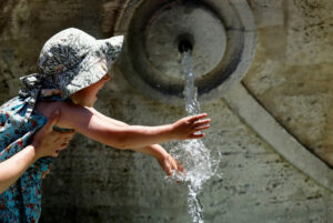 A-child-cools-off-at-Fontana-della-Barcaccia-at-the-Spanish-Steps-during-a-heat-wave-across-Italy-as-temperatures-are-expected-to-rise-further-in-the-coming-days-in-Rome
