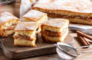 SpongeCakeWithApplesOnAWoodenBoardOnThe