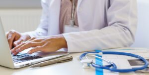 Cropped,Photo,Of,Female,Doctor,In,White,Uniform,Working,On